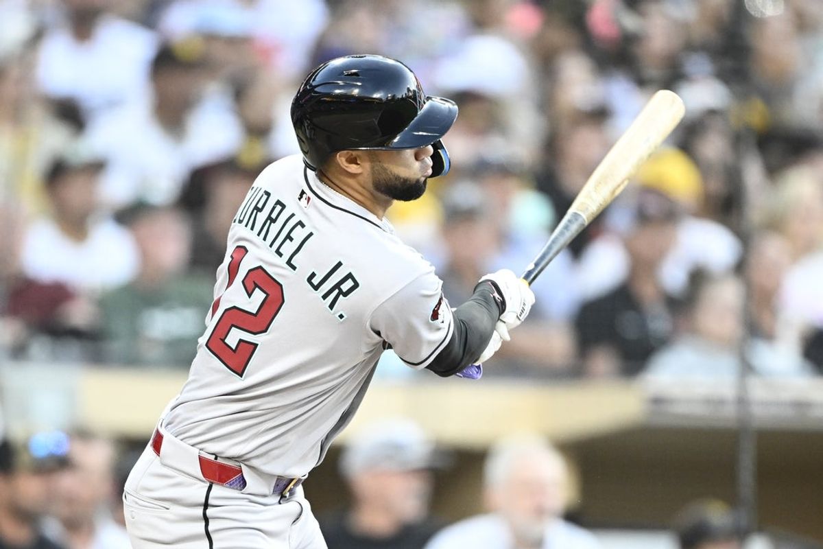 Jul 7, 2025; San Diego, California, USA; Arizona Diamondbacks left fielder Lourdes Gurriel Jr. (12) hits an RBI single during the third inning against the San Diego Padres at Petco Park. Mandatory Credit: Denis Poroy-Imagn Images