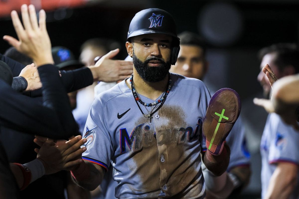 Jul 7, 2025; Cincinnati, Ohio, USA; Miami Marlins outfielder Derek Hill (3) high fives teammates after scoring on a sacrifice fly out hit by shortstop Javier Sanoja (not pictured) in the sixth inning against the Cincinnati Reds at Great American Ball Park. Mandatory Credit: Katie Stratman-Imagn Images