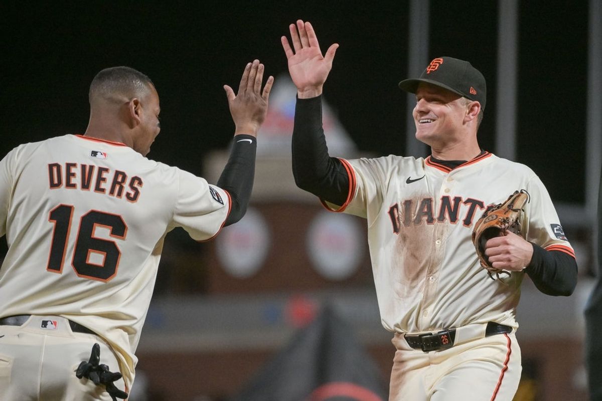 Jul 7, 2025; San Francisco, California, USA; San Francisco Giants third baseman Matt Chapman (26) high fives designated hitter Rafael Devers (16) after defeating the Philadelphia Phillies at Oracle Park. Mandatory Credit: Ed Szczepanski-Imagn Images