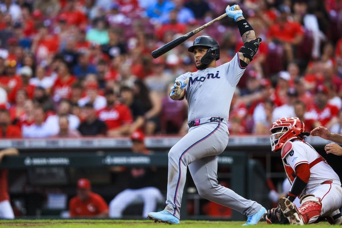 Jul 8, 2025; Cincinnati, Ohio, USA; Miami Marlins catcher Agustin Ramirez (50) hits a RBI double in the third inning against the Cincinnati Reds at Great American Ball Park. Mandatory Credit: Katie Stratman-Imagn Images