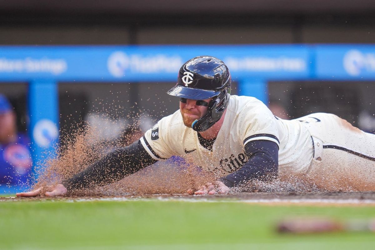 Jul 8, 2025; Minneapolis, Minnesota, USA;  Minnesota Twins designated hitter Ryan Jeffers (27) slides home against the Chicago Cubs in the first inning at Target Field. Mandatory Credit: Brad Rempel-Imagn Images