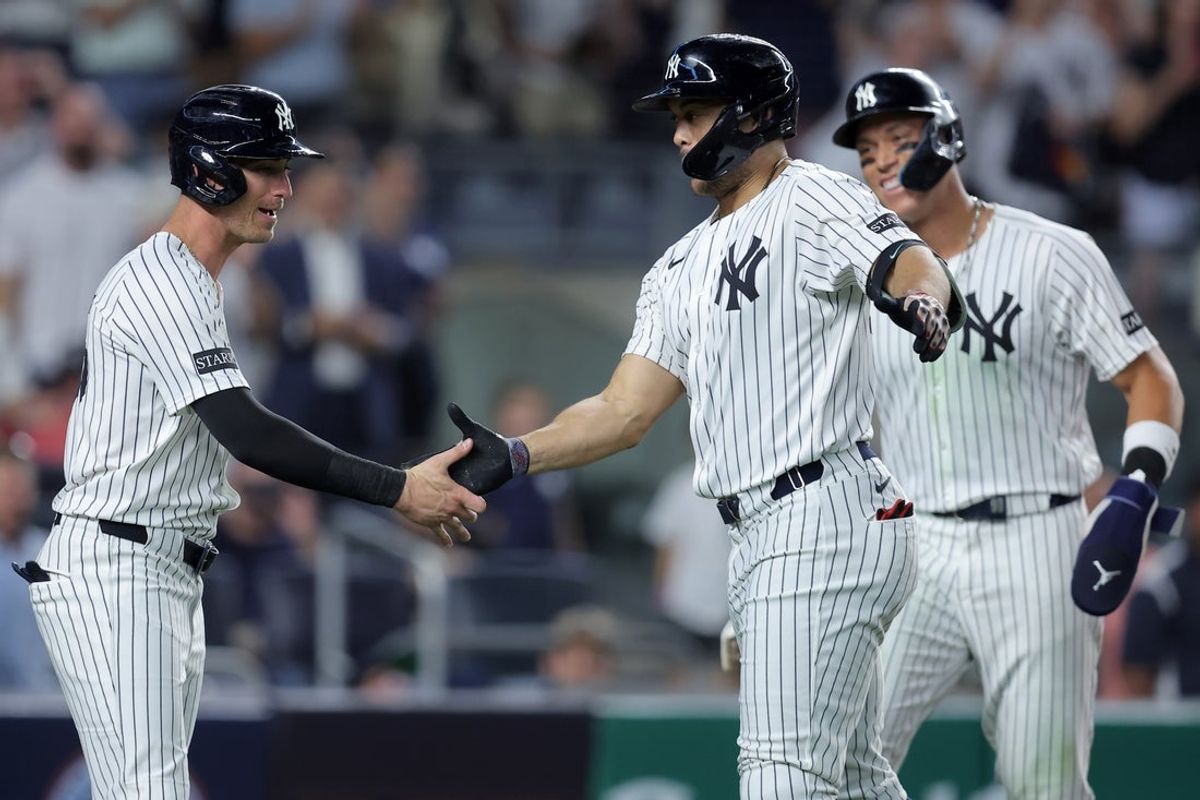 Jul 8, 2025; Bronx, New York, USA; New York Yankees designated hitter Giancarlo Stanton (27) celebrates his three run home run against the Seattle Mariners with center fielder Cody Bellinger (35) and right fielder Aaron Judge (99) during the sixth inning at Yankee Stadium. Mandatory Credit: Brad Penner-Imagn Images