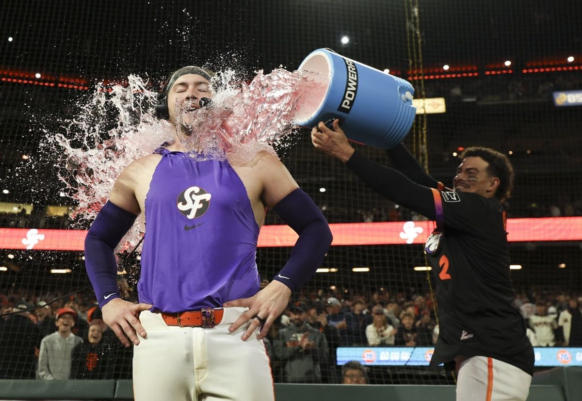 Jul 8, 2025; San Francisco, California, USA; San Francisco Giants shortstop Willy Adames (2) dumps powerade on catcher Patrick Bailey (14) as Bailey is interviewed after hitting a three-run home run during the ninth inning for a walk-off win against the Philadelphia Phillies at Oracle Park. Mandatory Credit: Kelley L Cox-Imagn Images
