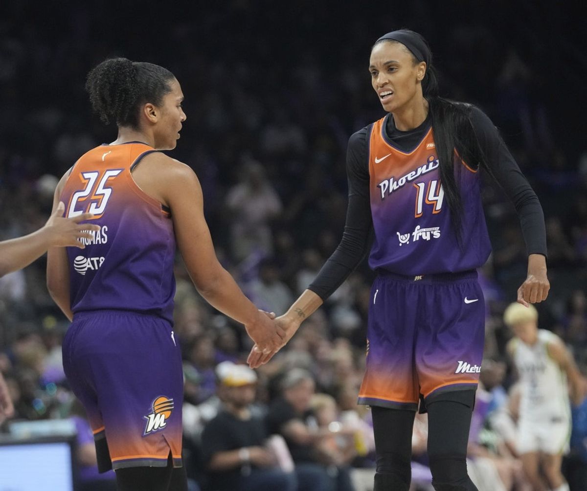 Phoenix Mercury forward Alyssa Thomas (25) slaps hands with Phoenix Mercury forward DeWanna Bonner (14) during the first quarter against the Minnesota Lynx at PHX Arena on July 9, 2025.
