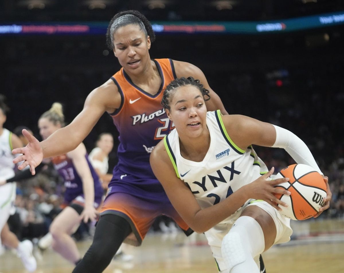 Phoenix Mercury forward Alyssa Thomas (25) defends against Minnesota Lynx forward Napheesa Collier (24) during the third quarter at PHX Arena on July 9, 2025.