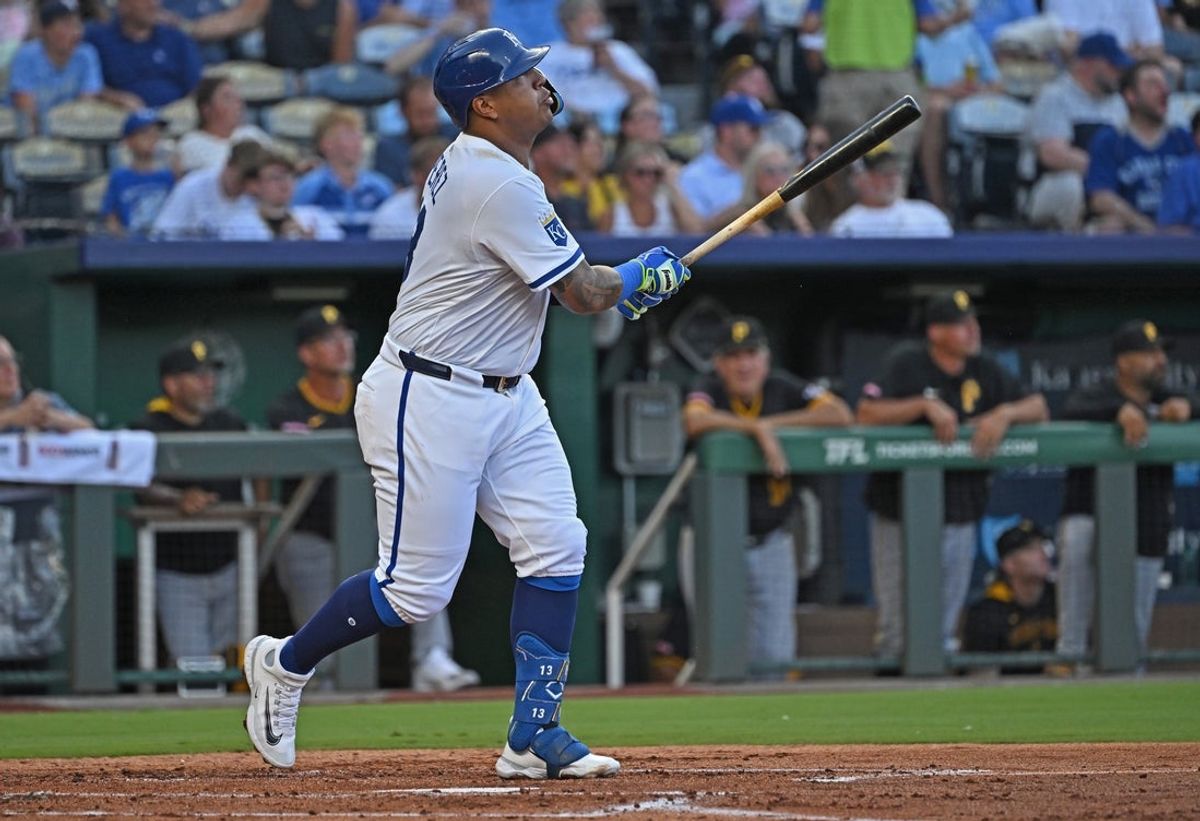 Jul 9, 2025; Kansas City, Missouri, USA;  Kansas City Royals first baseman Salvador Perez (13) hits a solo home run in the second inning against the Pittsburgh Pirates at Kauffman Stadium. Mandatory Credit: Peter Aiken-Imagn Images