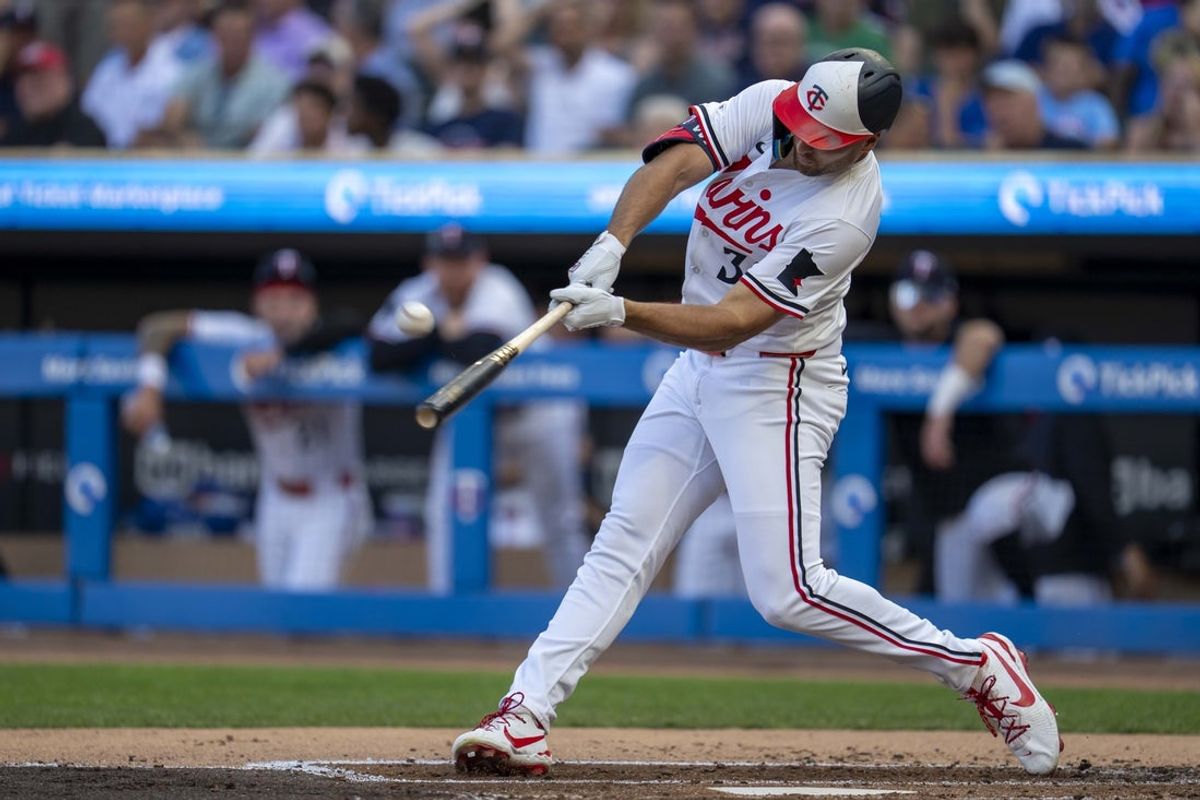 Jul 9, 2025; Minneapolis, Minnesota, USA; Minnesota Twins right fielder Matt Wallner (38) hits a solo home run against the Chicago Cubs in the first inning at Target Field. Mandatory Credit: Jesse Johnson-Imagn Images