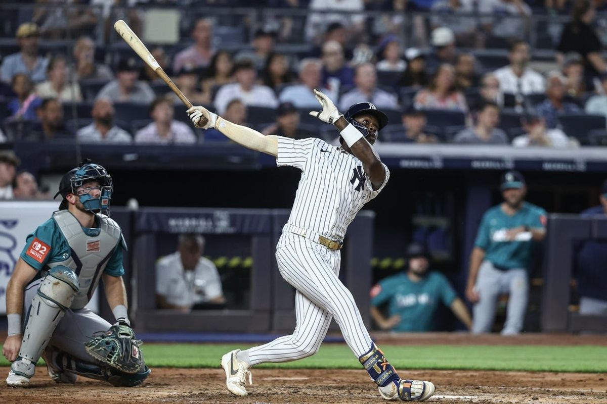 Jul 9, 2025; Bronx, New York, USA;  New York Yankees second baseman Jazz Chisholm Jr. (13) hits a two run home run in the fifth inning against the Seattle Mariners at Yankee Stadium. Mandatory Credit: Wendell Cruz-Imagn Images