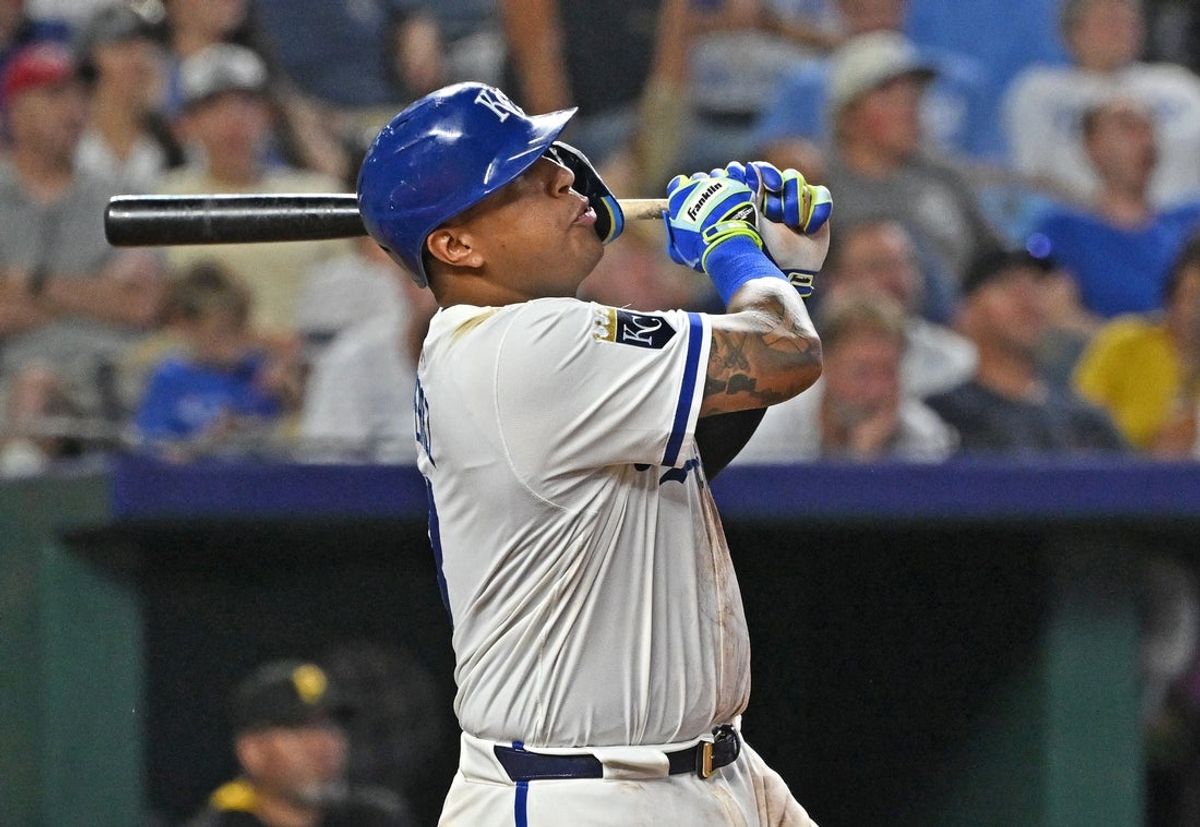 Jul 9, 2025; Kansas City, Missouri, USA;  Kansas City Royals first baseman Salvador Perez (13) hits a solo home run in the eighth inning against the Pittsburgh Pirates at Kauffman Stadium. Mandatory Credit: Peter Aiken-Imagn Images