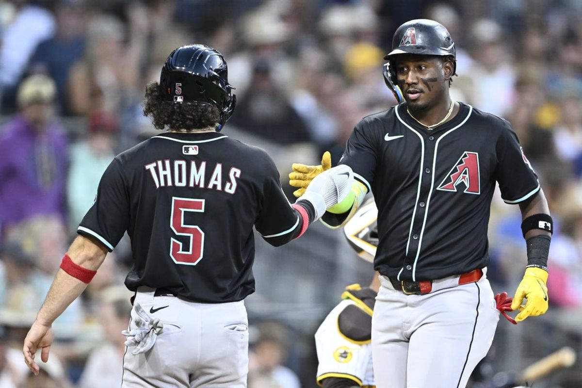 Jul 9, 2025; San Diego, California, USA; Arizona Diamondbacks shortstop Geraldo Perdomo (2) is congratulated by Alek Thomas (5) after hitting a grand slam during the fifth inning against the San Diego Padres at Petco Park. Mandatory Credit: Denis Poroy-Imagn Images