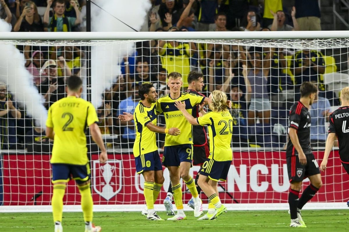 Jul 9, 2025; Nashville, Tennessee, USA;  Nashville SC forward Sam Surridge (9) celebrates his goal with his teammates against the D.C. United during the second half at GEODIS Park. Mandatory Credit: Steve Roberts-Imagn Images