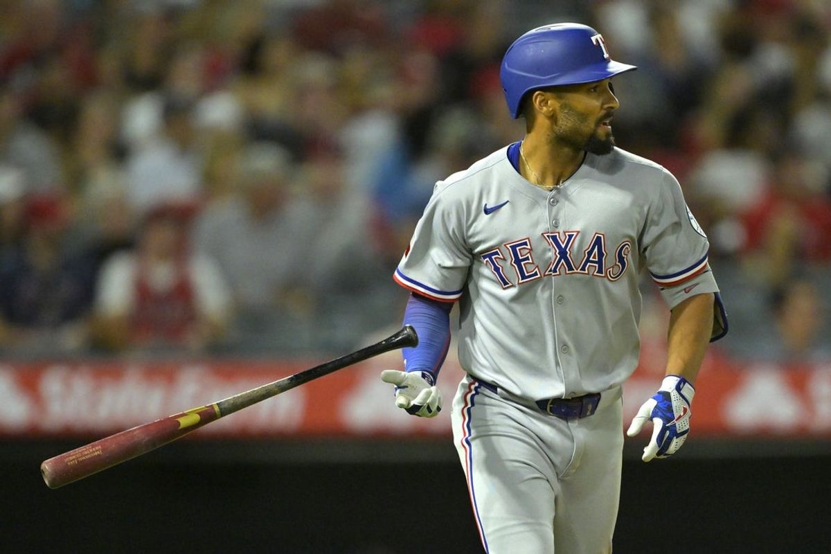 Jul 9, 2025; Anaheim, California, USA;  Texas Rangers second baseman Marcus Semien (2) hits a two-run home run during the seventh inning against the Los Angeles Angels at Angel Stadium. Mandatory Credit: Jayne Kamin-Oncea-Imagn Images