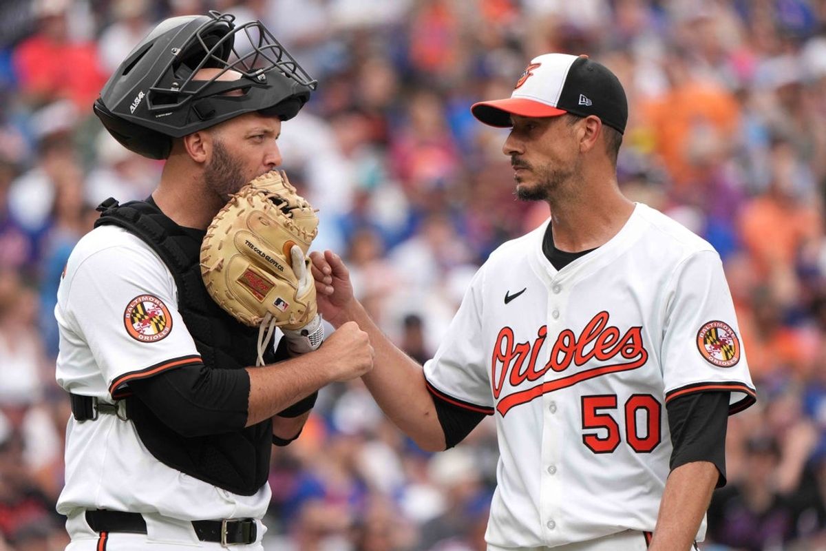 Jul 10, 2025; Baltimore, Maryland, USA;  Baltimore Orioles catcher Jacob Stallings (left) greets pitcher Charlie Morton (right) after the third inning against the New York Mets at Oriole Park at Camden Yards. Mandatory Credit: Mitch Stringer-Imagn Images