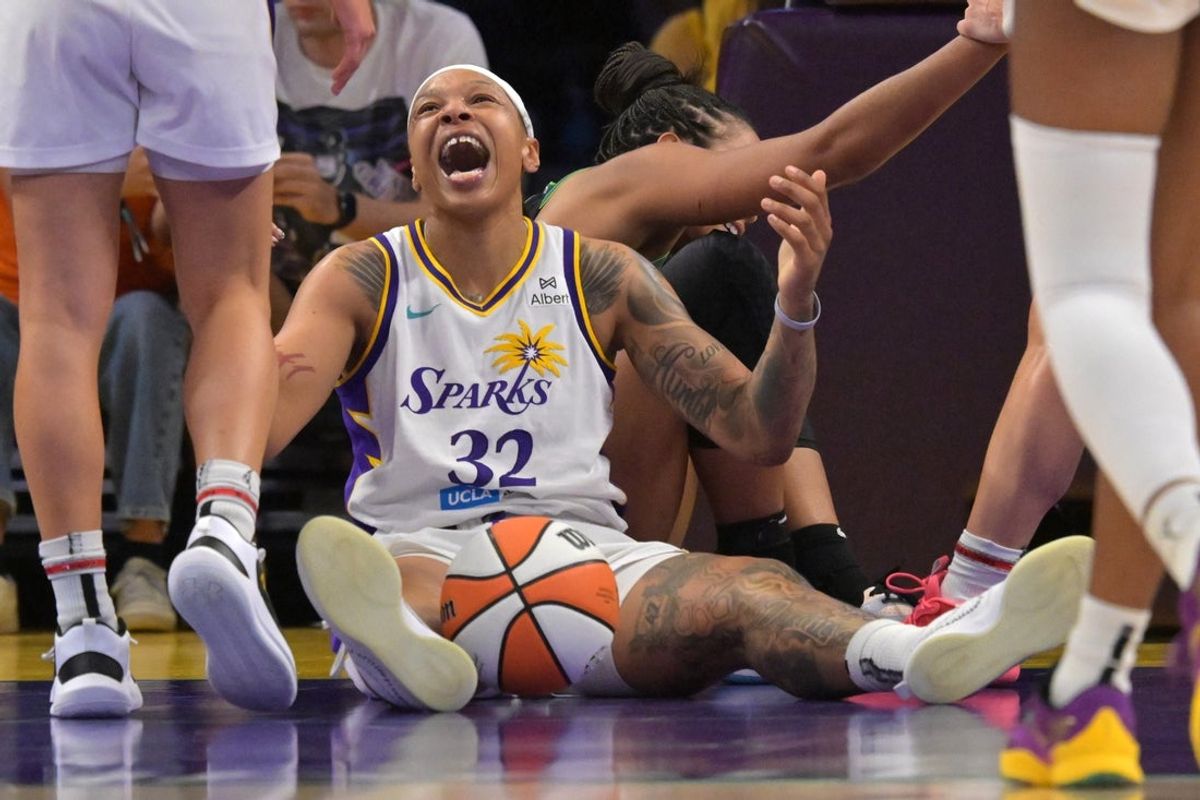Jul 10, 2025; Los Angeles, California, USA;  Los Angeles Sparks forward Emma Cannon (32) reacts after scrambling for a loose ball in the second half against the Minnesota Lynx at Crypto.com Arena. Mandatory Credit: Jayne Kamin-Oncea-Imagn Images