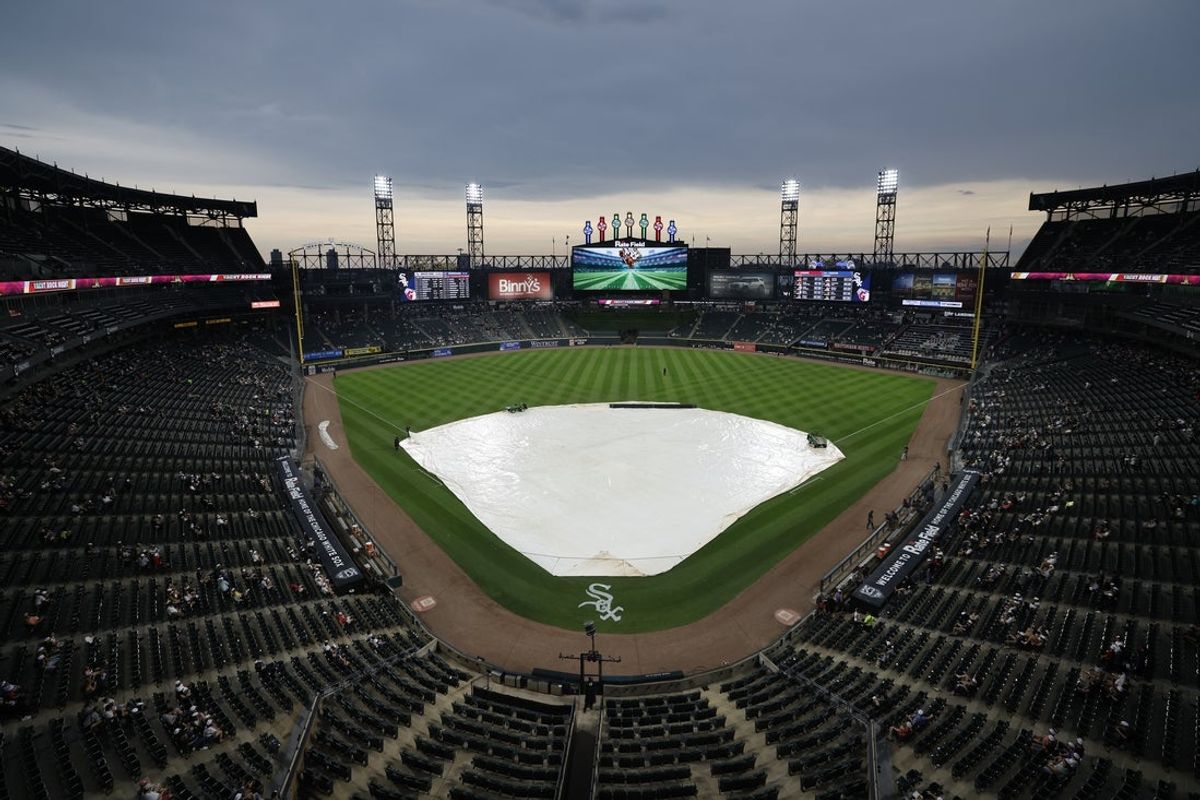 Jul 10, 2025; Chicago, Illinois, USA; The tarp covers the field during the rain delay of a baseball game between the Chicago White Sox and Cleveland Guardians at Rate Field. Mandatory Credit: Kamil Krzaczynski-Imagn Images