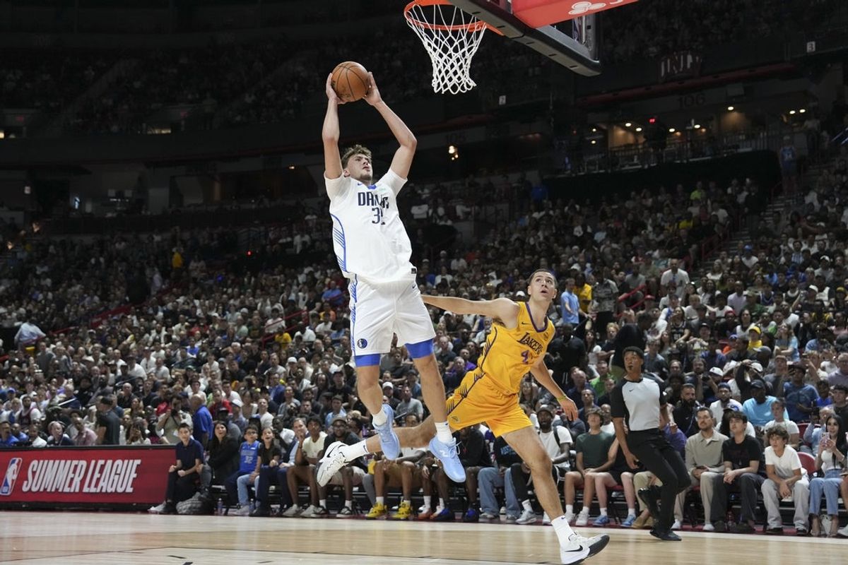 Jul 10, 2025; Las Vegas, NV, USA; Dallas Mavericks forward Cooper Flagg (32) is fouled by Los Angeles Lakers forward Cole Swider (41) in the first quarter of their game at Thomas & Mack Center. Mandatory Credit: Candice Ward-Imagn Images