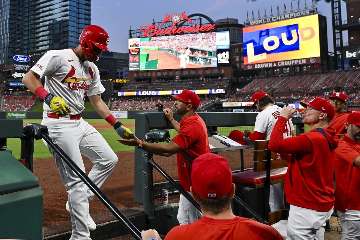 Jul 10, 2025; St. Louis, Missouri, USA;  St. Louis Cardinals left fielder Lars Nootbaar (21) is congratulated by manager Oliver Marmol (37) after he scored against the Washington Nationals during the sixth inning at Busch Stadium. Mandatory Credit: Jeff Curry-Imagn Images