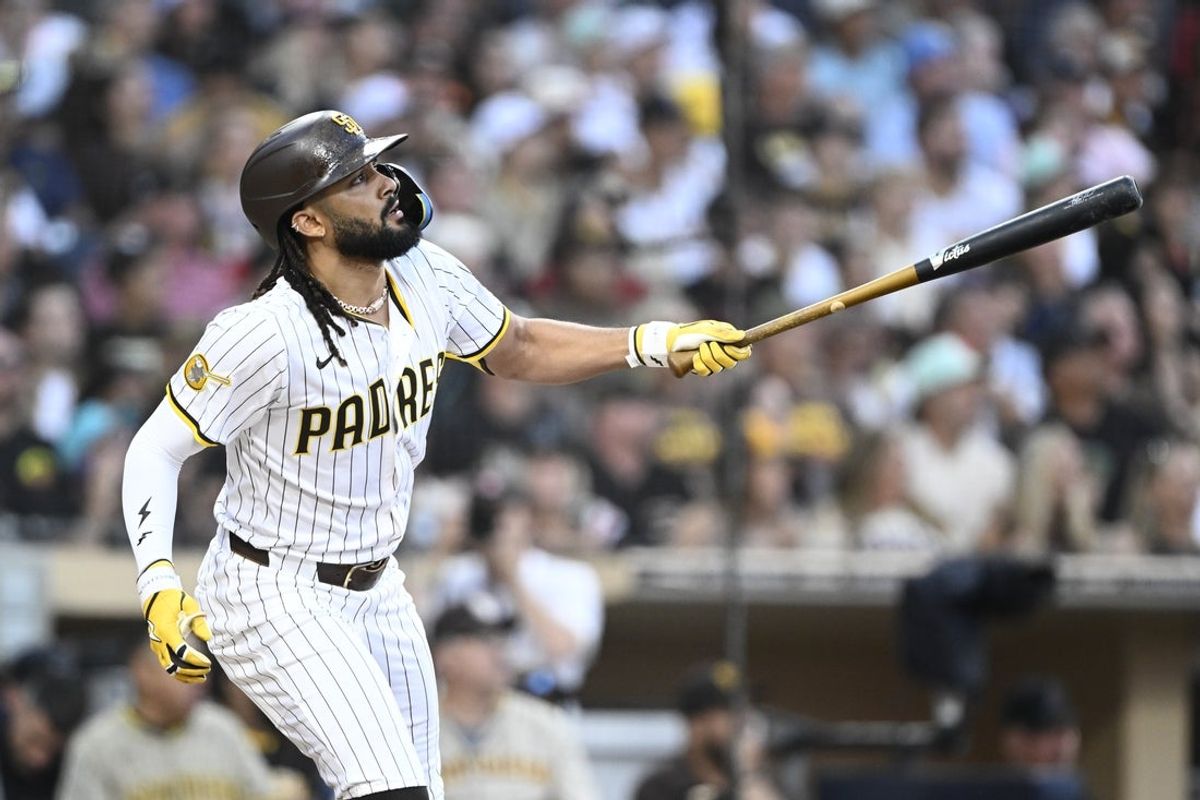Jul 10, 2025; San Diego, California, USA; San Diego Padres right fielder Fernando Tatis Jr. (23) hits a solo home run during the third inning against the Arizona Diamondbacks at Petco Park. Mandatory Credit: Denis Poroy-Imagn Images a