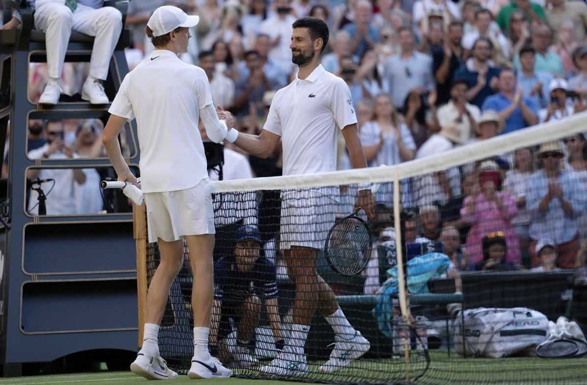 Jul 11, 2025; Wimbledon, United Kingdom; Jannik Sinner of Italy at the net with Novak Djokovic of Serbia after their match on day 12 at All England Lawn Tennis and Croquet Club. Mandatory Credit: Susan Mullane-Imagn Images