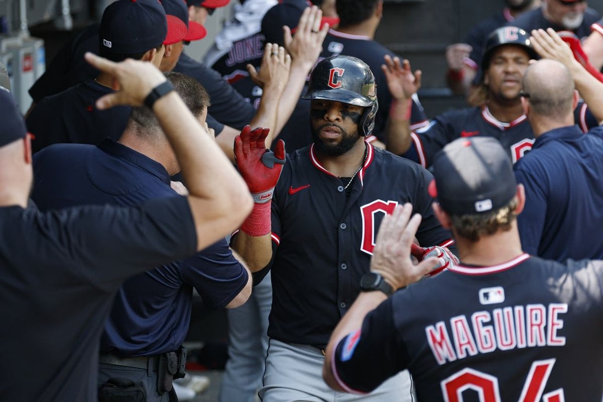 Jul 11, 2025; Chicago, Illinois, USA; Cleveland Guardians first baseman Carlos Santana (41) celebrates with teammates in the dugout after hitting a two-run home run against the Chicago White Sox during the sixth inning of game one of a doubleheader at Rate Field. Mandatory Credit: Kamil Krzaczynski-Imagn Images