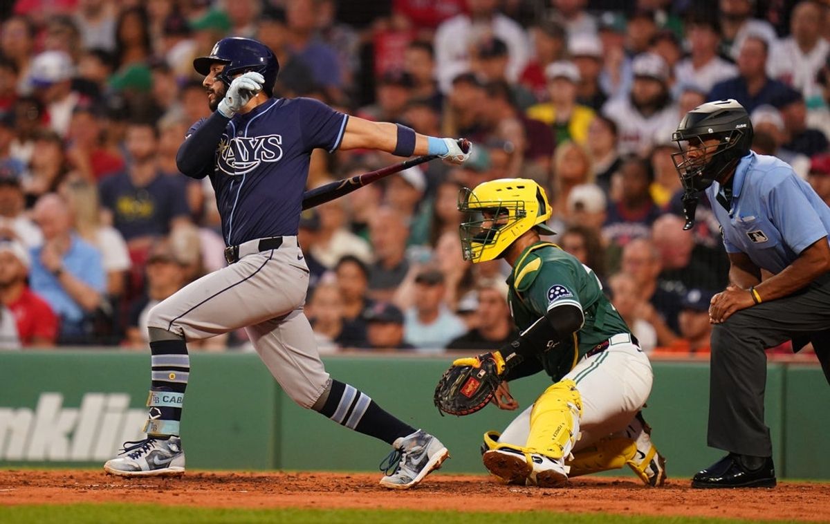 Jul 11, 2025; Boston, Massachusetts, USA; Tampa Bay Rays second base José Caballero (77) gets to first base on a fielding error against the Boston Red Sox in the third inning at Fenway Park. Mandatory Credit: David Butler II-Imagn Images