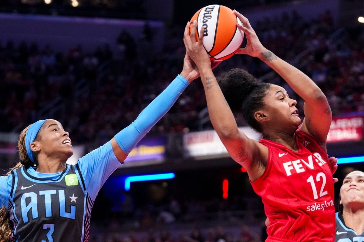 Indiana Fever forward Damiris Dantas (12) grabs the ball over Atlanta Dream guard Jordin Canada (3) on Friday, July 11, 2025, during a game between the Indiana Fever and the Atlanta Dream at Gainbridge Fieldhouse in Indianapolis.