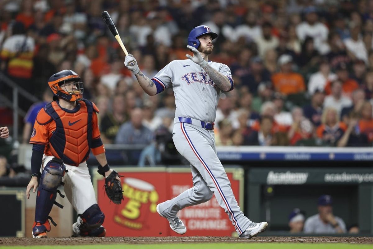 Jul 11, 2025; Houston, Texas, USA; Texas Rangers designated hitter Jonah Heim (28) drives in two runs with an RBI double during the third inning against the Houston Astros at Daikin Park. Mandatory Credit: Troy Taormina-Imagn Images