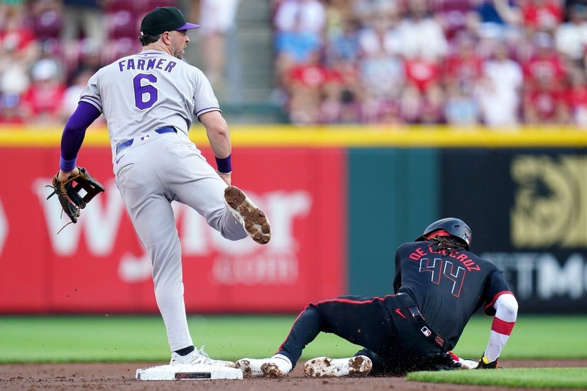 Colorado Rockies second baseman Kyle Farmer (6) throws a pass after tagging out Cincinnati Reds shortstop Elly De La Cruz (44) in the first inning of a MLB game between the Cincinnati Reds and Colorado Rockies, Friday, July 11, 2025, at Great American Ball Park in Downtown Cincinnati.