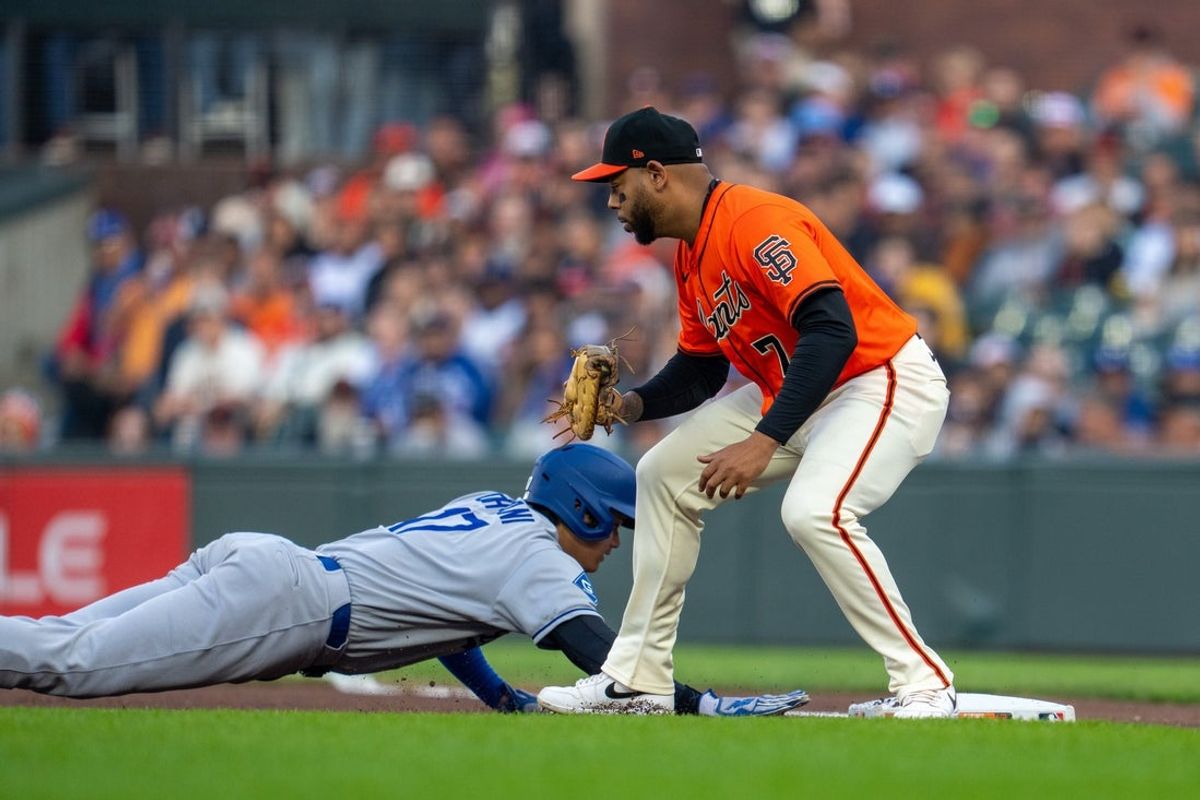 Jul 11, 2025; San Francisco, California, USA; Los Angeles Dodgers designated hitter Shohei Ohtani (17) dives back to first bass against San Francisco Giants first baseman Dominic Smith (7) during the first inning at Oracle Park. Mandatory Credit: Neville E. Guard-Imagn Images