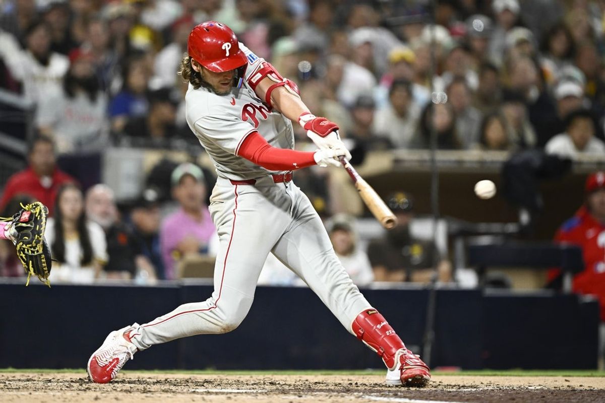 Jul 11, 2025; San Diego, California, USA; Philadelphia Phillies third baseman Alec Bohm (28) hits a single during the eighth inning against the San Diego Padres at Petco Park. Mandatory Credit: Denis Poroy-Imagn Images