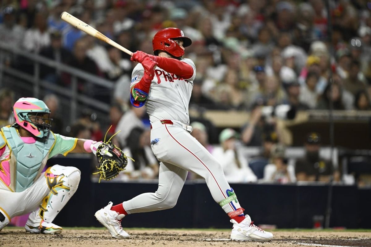 Jul 11, 2025; San Diego, California, USA; Philadelphia Phillies first baseman Bryce Harper (3) hits a single during the eighth inning against the San Diego Padres at Petco Park. Mandatory Credit: Denis Poroy-Imagn Images