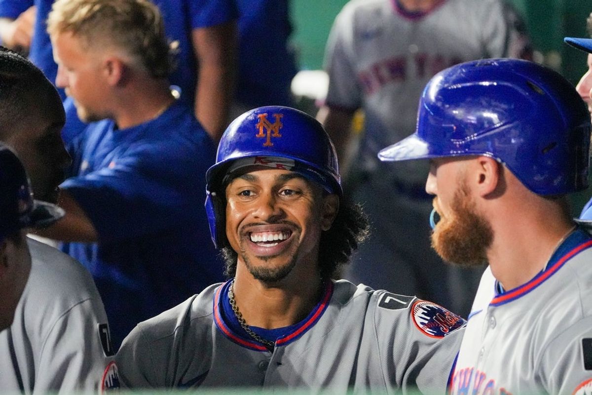 Jul 11, 2025; Kansas City, Missouri, USA; New York Mets shortstop Francisco Lindor (12) celebrates in the dugout  after scoring against the Kansas City Royals in the ninth inning at Kauffman Stadium. Mandatory Credit: Denny Medley-Imagn Images