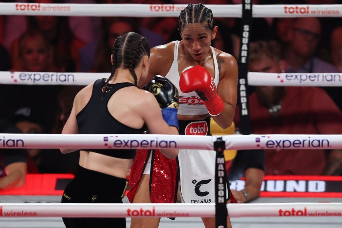Jul 11, 2025; New York, New York, UNITED STATES; Amanda Serrano (red gloves) and Katie Taylor (blue gloves) fight during the undisputed super lightweight championship boxing bout at Madison Square Garden. Mandatory Credit: Vincent Carchietta-Imagn Images