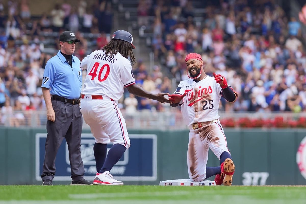 Jul 12, 2025; Minneapolis, Minnesota, USA; Minnesota Twins outfielder Byron Buxton (25) celebrates his triple with third base coach coach Tommy Watkins (40) against the Pittsburgh Pirates in the second inning at Target Field. Mandatory Credit: Brad Rempel-Imagn Images
