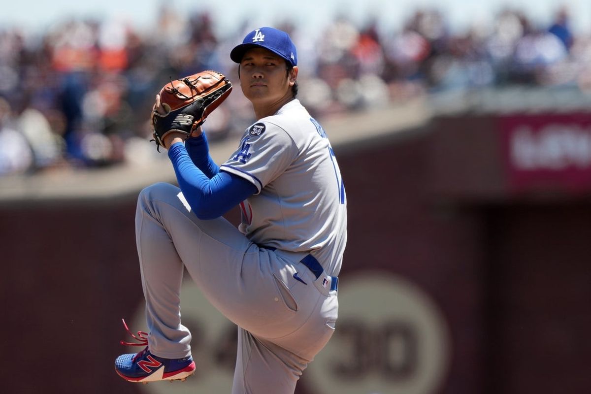 Jul 12, 2025; San Francisco, California, USA; Los Angeles Dodgers starting pitcher Shohei Ohtani (17) throws a pitch against the San Francisco Giants during the first inning at Oracle Park. Mandatory Credit: Darren Yamashita-Imagn Images