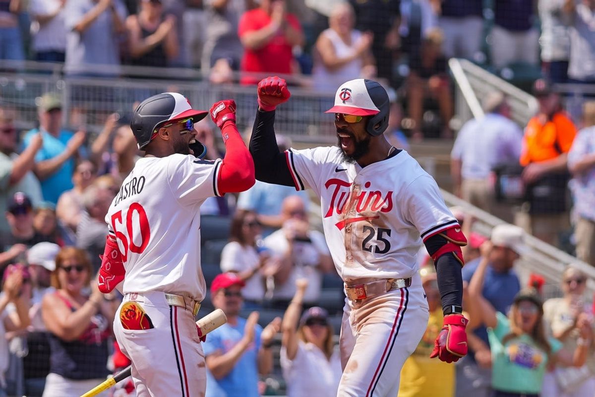 Jul 12, 2025; Minneapolis, Minnesota, USA; Minnesota Twins outfielder Byron Buxton (25) celebrates his home run for the cycle with outfielder Willi Castro (50) against the Pittsburgh Pirates in the seventh inning at Target Field. Mandatory Credit: Brad Rempel-Imagn Images