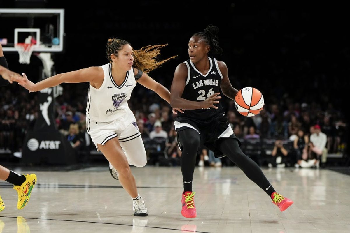 Jul 12, 2025; Las Vegas, Nevada, USA; Las Vegas Aces guard Jewell Loyd (24) controls the ball against Golden State Valkyries guard Veronica Burton (22) during the first half of a WNBA basketball game at Michelob Ultra Arena. Mandatory Credit: Lucas Peltier-Imagn Images