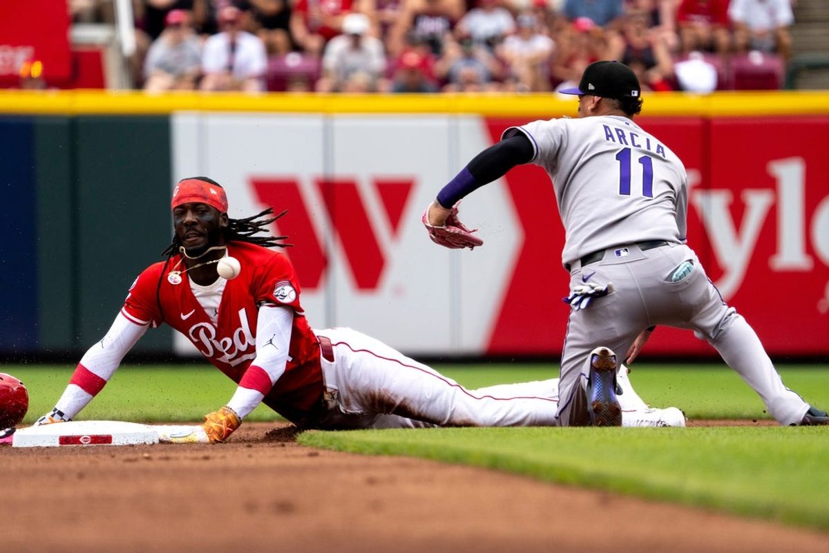 Cincinnati Reds shortstop Elly De La Cruz (44) steals second as Colorado Rockies shortstop Orlando Arcia (11) loses the throw from home in the first inning between Cincinnati Reds and Colorado Rockies at Great American Ball Park in Cincinnati on Saturday, July 12, 2025.