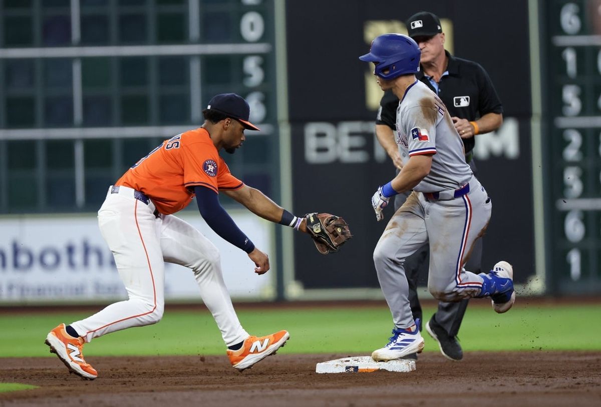 Jul 12, 2025; Houston, Texas, USA; Texas Rangers left fielder Sam Haggerty (0) slides into second safely as Houston Astros center fielder Brice Matthews (28) is late with the tag in the third inning at Daikin Park. Mandatory Credit: Thomas Shea-Imagn Images