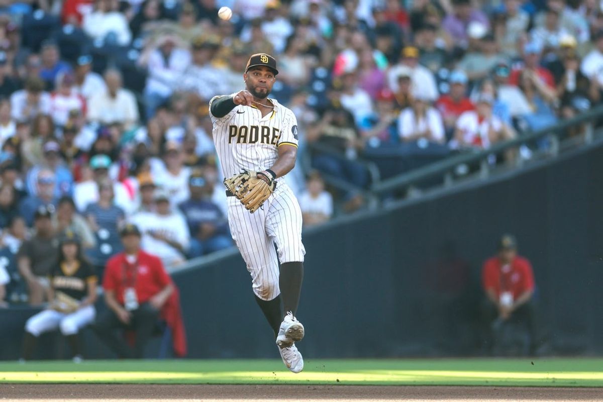 Jul 12, 2025; San Diego, California, USA; San Diego Padres shortstop Xander Bogaerts (2) makes the throw to first base for an out during the fourth inning against the Philadelphia Phillies at Petco Park. Mandatory Credit: David Frerker-Imagn Images