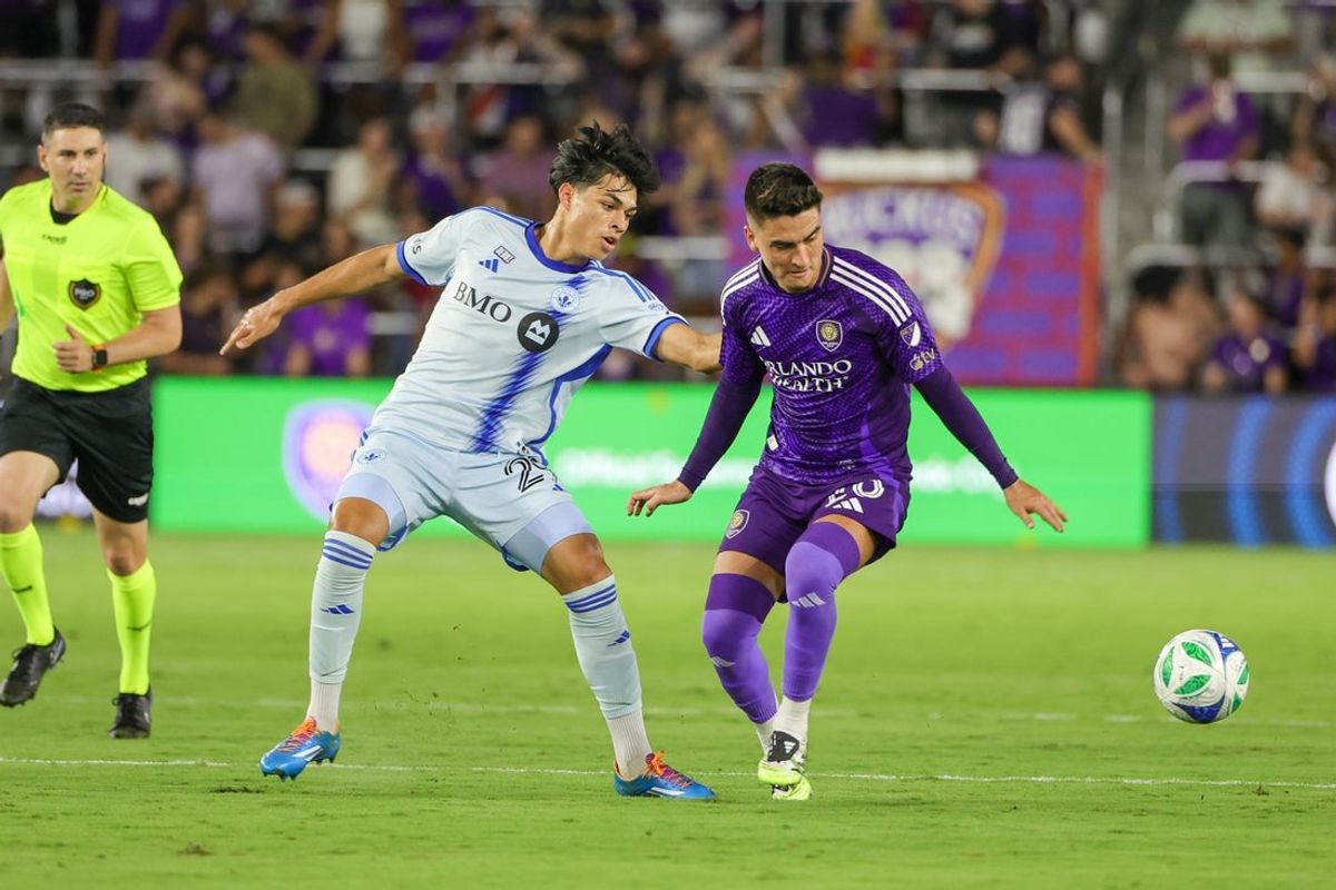 Jul 12, 2025; Orlando, Florida, USA; CF Montréal forward Olger Escobar (29) and Orlando City midfielder Eduard Atuesta (20) battle for the ball during the second half at Inter&Co Stadium. Mandatory Credit: Mike Watters-Imagn Images