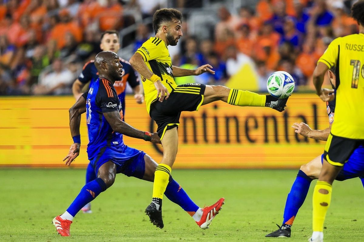 Jul 12, 2025; Cincinnati, Ohio, USA; Columbus Crew forward Diego Rossi (10) kicks the ball against FC Cincinnati midfielder Brian Anunga (27) in the first half at TQL Stadium. Mandatory Credit: Katie Stratman-Imagn Images
