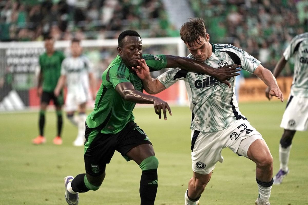 Jul 12, 2025; Austin, Texas, USA; Austin FC forward Osman Bukari (11) and New England Revolution defender Will Sands (23) battle for the ball during the first half at Q2 Stadium. Mandatory Credit: Dustin Safranek-Imagn Images