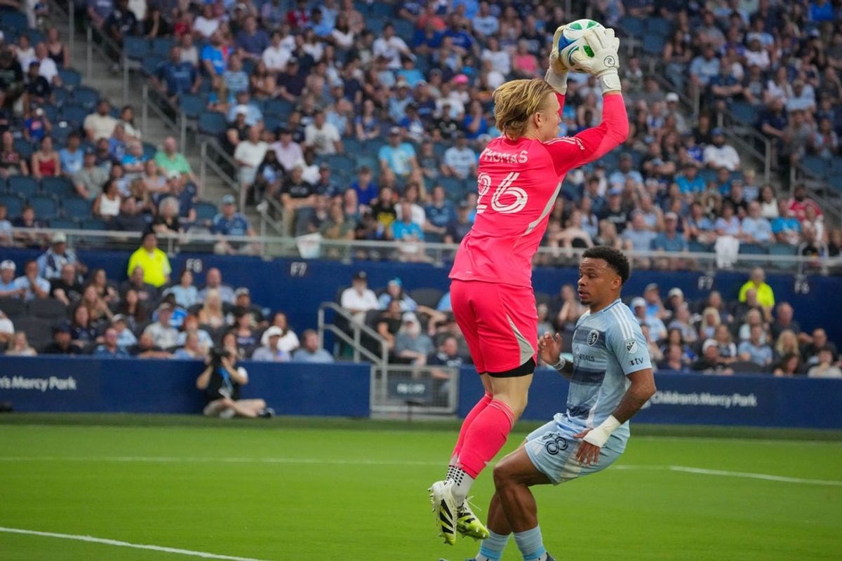 Jul 12, 2025; Kansas City, Kansas, USA; Seattle Sounders FC goalkeeper Andrew Thomas (26) stops a shot on goal against Sporting Kansas City during the first half of the match at Children's Mercy Park. Mandatory Credit: Denny Medley-Imagn Images