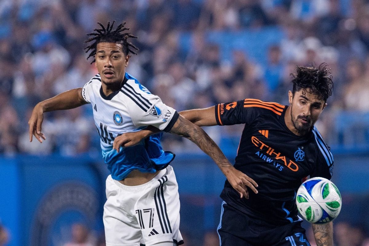 Jul 12, 2025; Charlotte, North Carolina, USA; Charlotte FC forward Idan Toklomati (17) and New York City defender Thiago Martins (13) chase the ball during the first half at Bank of America Stadium. Mandatory Credit: Scott Kinser-Imagn Images