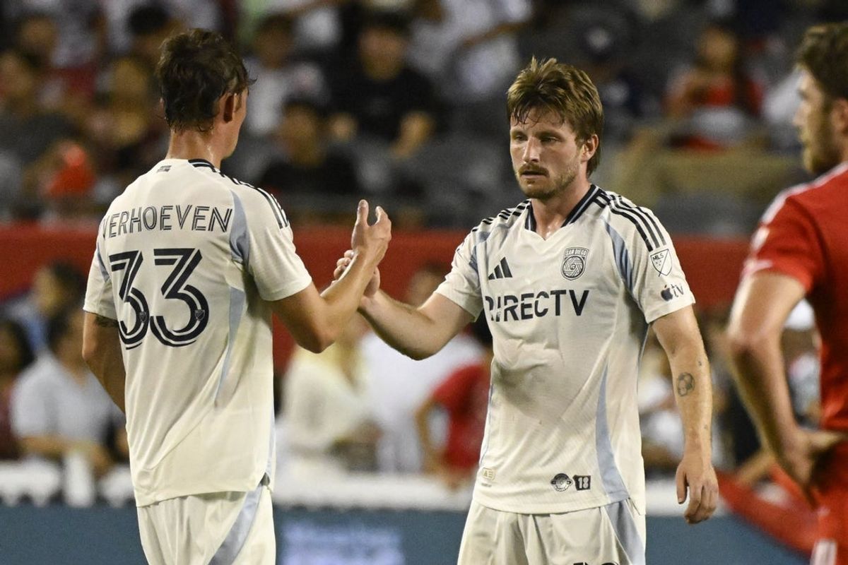 Jul 12, 2025; Chicago, Illinois, USA;  San Diego FC defender Oscar Verhoeven (33) and midfielder Anders Dreyer (10) celebrate after the game against the Chicago Fire at Soldier Field. Mandatory Credit: Matt Marton-Imagn Images