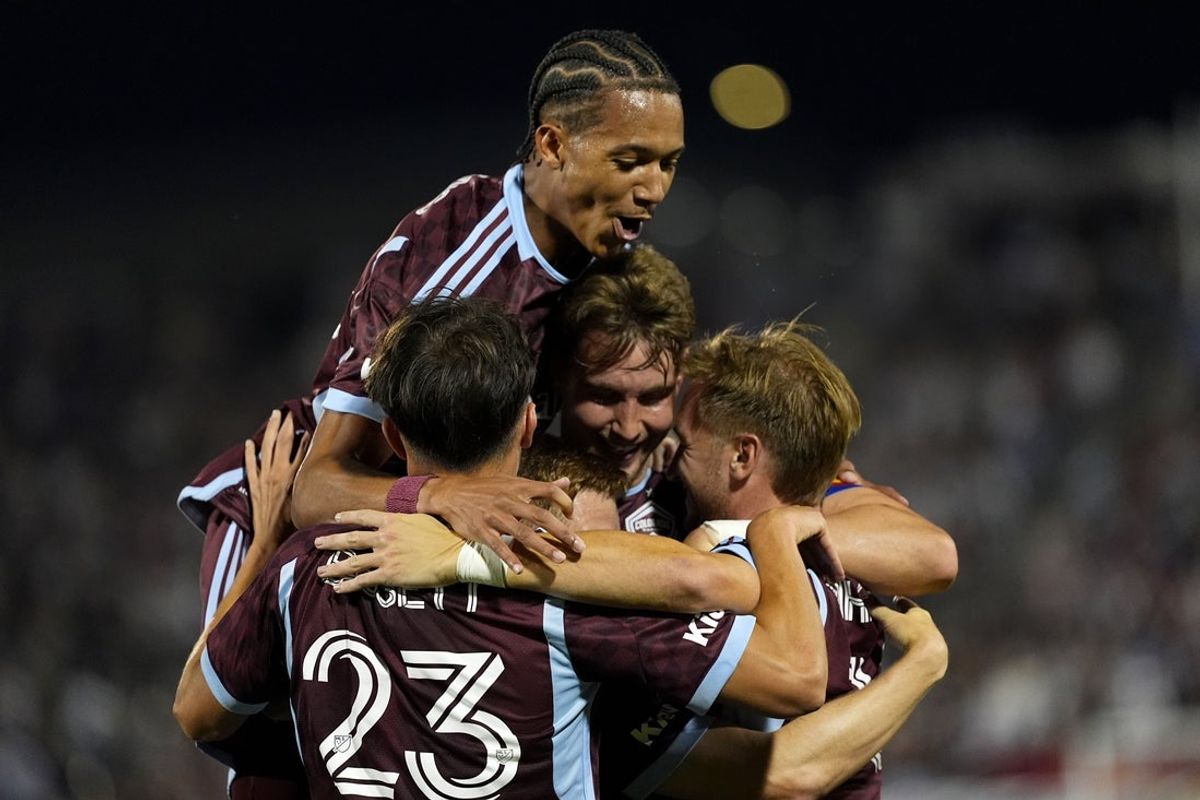 Jul 12, 2025; Commerce City, Colorado, USA; Colorado Rapids defender Andreas Maxso (5) (center) celebrates his goal with forward Calvin Harris (14),midfielder Cole Bassett (23) and midfielder Djordje Mihailovic (10) in the second half against the Vancouver Whitecaps at Dick's Sporting Goods Park. Mandatory Credit: Ron Chenoy-Imagn Images