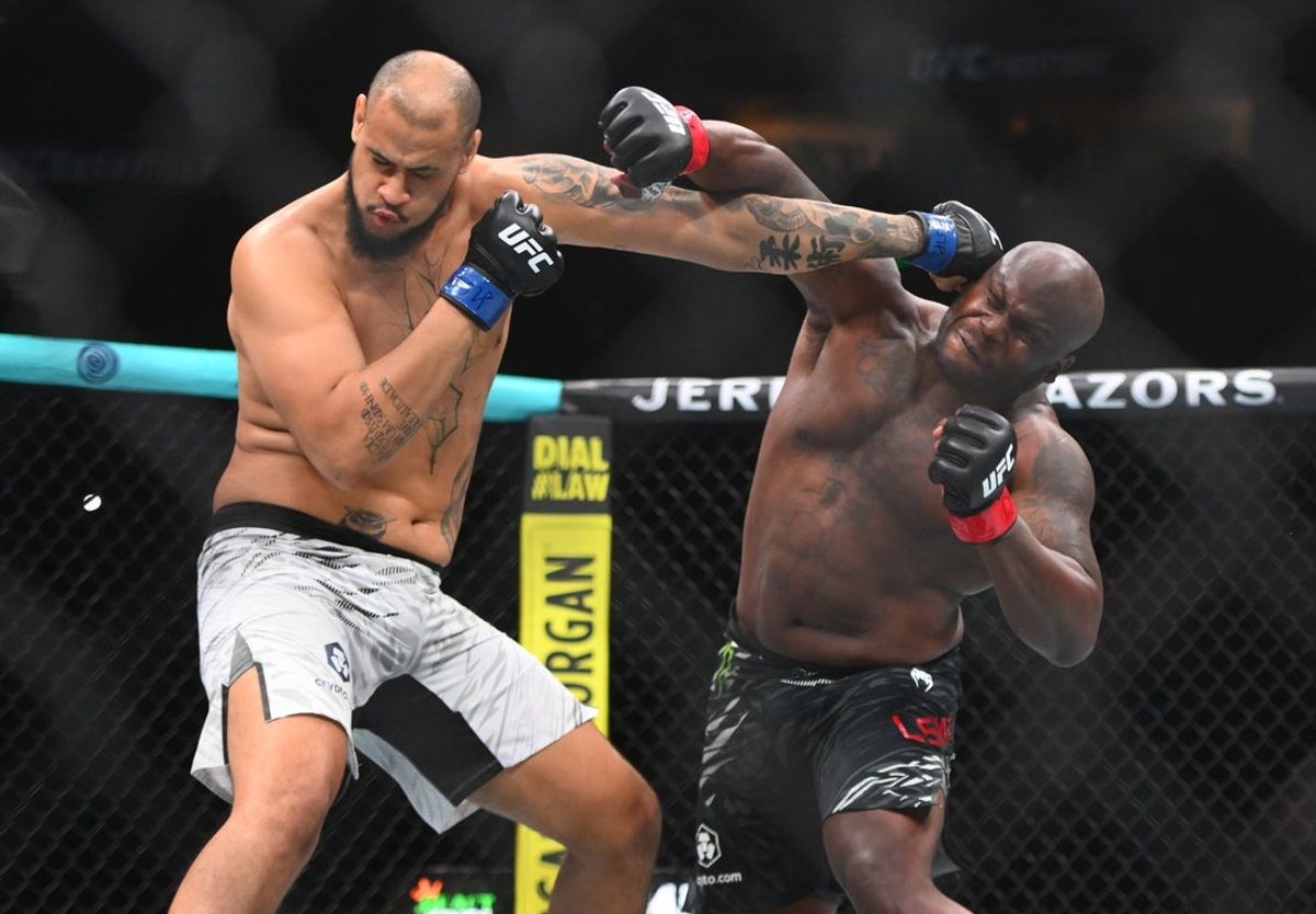 Jul 12, 2025; Nashville, Tennessee, United States; Derrick Lewis (red gloves) fights Tallison Teixeira (blue gloves) in a heavyweight bout during UFC Fight Night at Bridgestone Arena. Mandatory Credit: Steve Roberts-Imagn Images