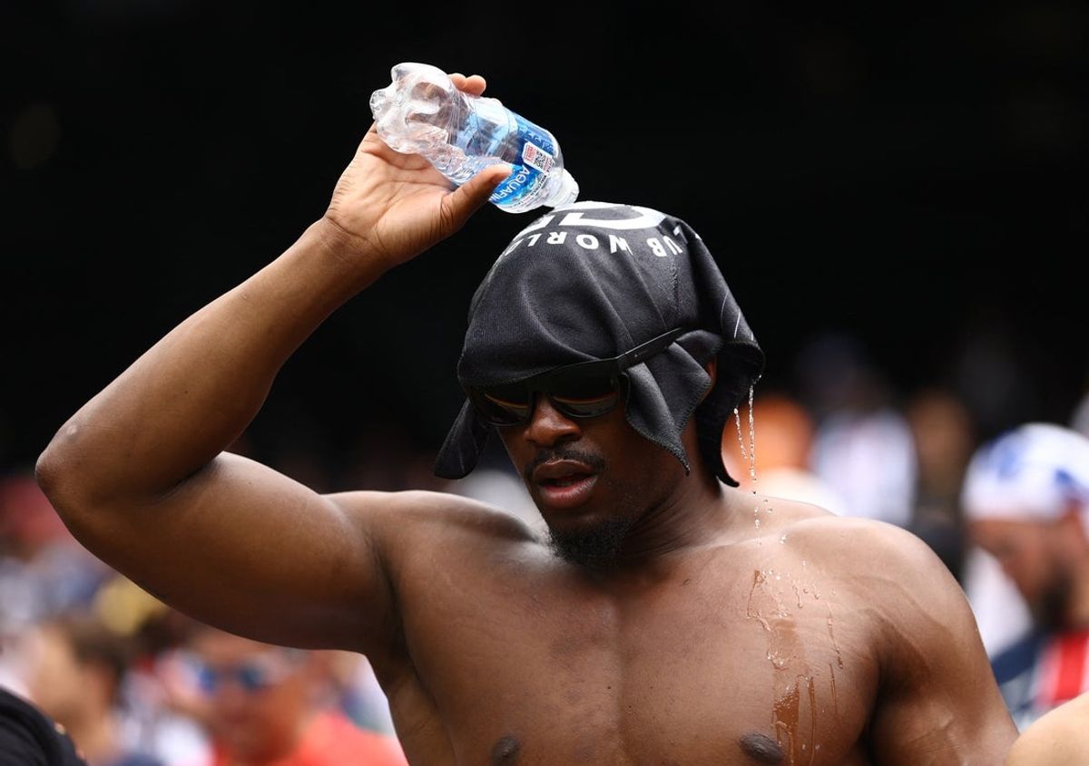 Jul 13, 2025; East Rutherford, New Jersey, USA; A fan pours water over his head to cool down inside the stadium before the final of the 2025 FIFA Club World Cup at MetLife Stadium. Mandatory Credit: Lee Smith-Reuters via Imagn Images