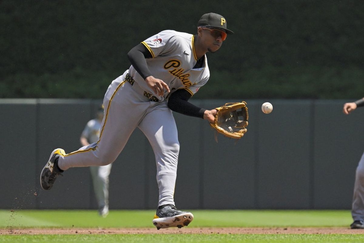 Jul 13, 2025; Minneapolis, Minnesota, USA;  Pittsburgh Pirates infielder Ke'Bryan Hayes (13) fields a ground ball against the Minnesota Twins during the first inning at Target Field. Mandatory Credit: Nick Wosika-Imagn Images